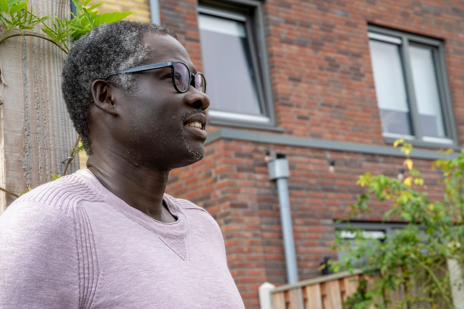 Nigerian man standing in his garden happy and content